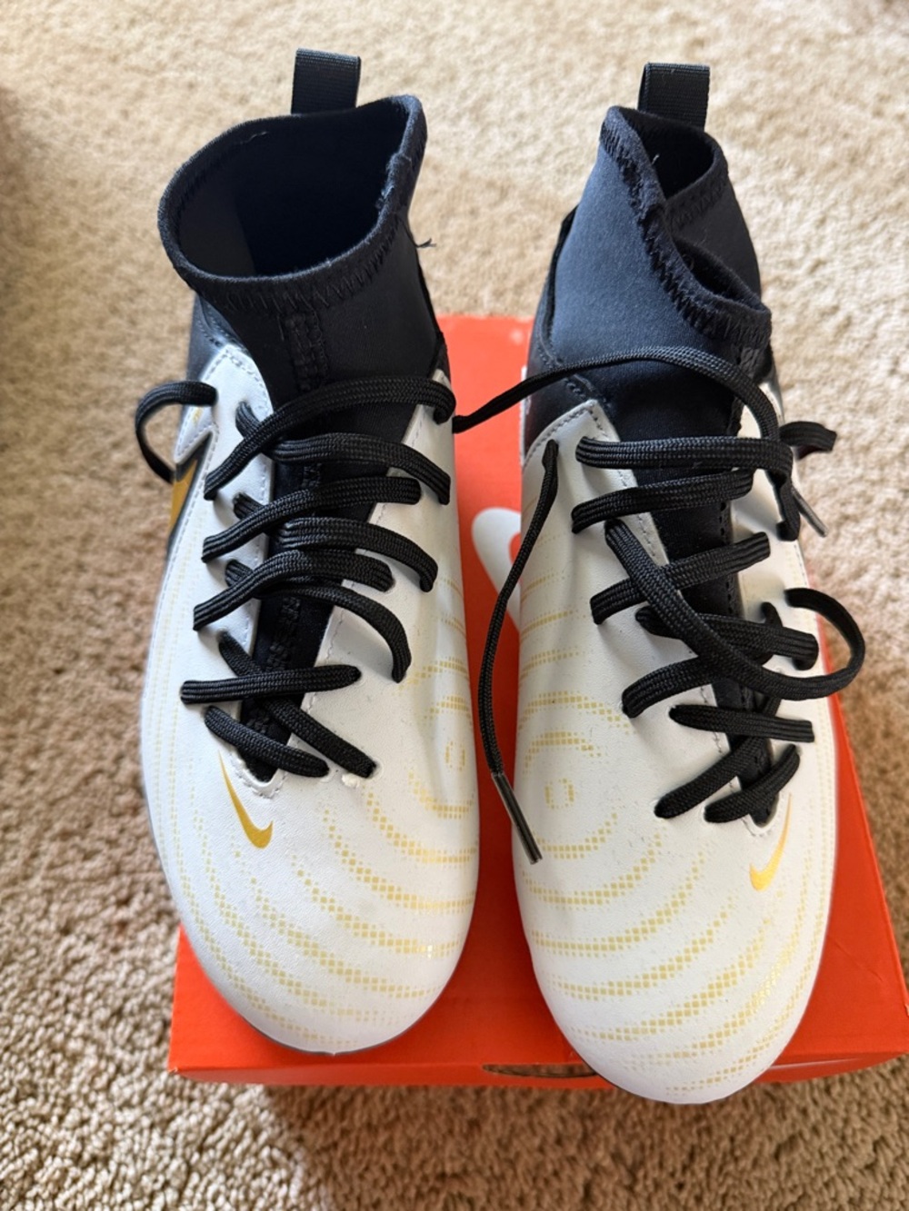 Kids Nike White and Black Soccer Cleats with Gold Swoosh Accents